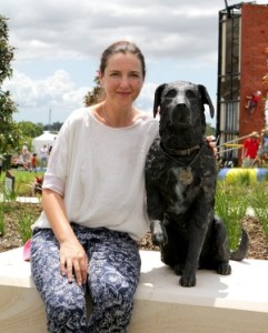 Brisbane sculptor Kathy McLay poses with her lifesize bronze statue of Sarbi, the former Australian Special Forces explosives detection dog at the opening of Sarbi Park at Warner Lakes. Photo: Michelle Smith